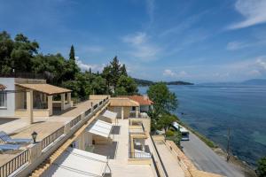 a building with a view of the water at El Greco hotel by Estia in Benitses