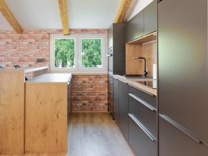 a kitchen with a brick wall and a window at Villa Morgan by Rent Istria in Umag +37 photos