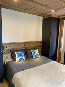 a bedroom with a bed with two pillows on it at Appartement Saint-Gervais-Les-Bains in Saint-Gervais-les-Bains