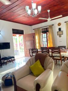 a living room with a couch and a table at Villa 70C in Dharga Town