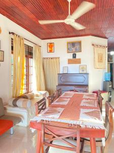 a living room with a table and a piano at Villa 70C in Dharga Town
