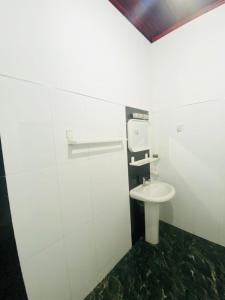a bathroom with a toilet and a sink at Villa 70C in Dharga Town