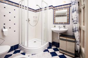a bathroom with a toilet, sink, and bathtub at Prague Siesta Apartments in Prague