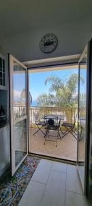 a room with a view of a patio with a table at MAGIK hill in Pizzo +27 photos