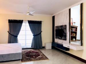 a bedroom with a bed and a large window at Royal Palace Boutique Hotel in Islamabad