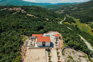 an aerial view of a house on a hill with a road at Vila Agape in Lovreć