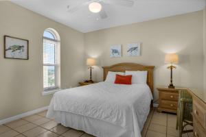 a bedroom with a white bed and two windows at The Palms #601 in Fort Walton Beach +38 photos