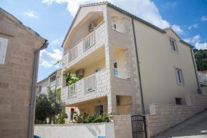 a large white building with balconies on it at Aurora Apartments in Bol