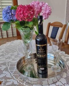 a bottle of wine sitting on a table with flowers at Antonny apartment in Zvekovica