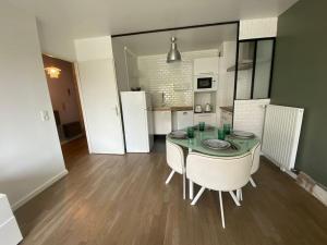 een keuken met een tafel en stoelen in een kamer bij Appartement proche Paris & Orly in Chevilly-Larue