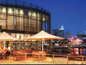 a restaurant with tables and umbrellas in front of a building at ToorakwhiteHouse3GrandKingBedrooms1BigGarden in Melbourne