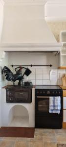 a kitchen with a stove and a bird statue on the counter at Hotell Örnen in Torsby
