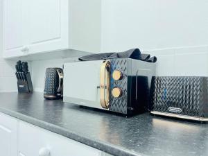 a toaster oven sitting on a counter in a kitchen at Darlington City Flat in Darlington