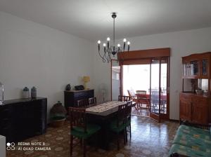 a dining room with a table and chairs in a room at Villetta Aurora in Lipari