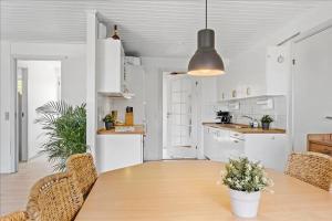 a kitchen and dining room with a table and chairs at House near public transport in Lystrup