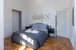a bedroom with a bed with two towels on it at Lago Design Guest House - Como Center in Como