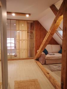 a attic room with a bed and a window at Apartamenty Pod Sosnami in Sopot