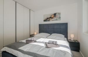 a bedroom with a large bed with two towels on it at Apartment Manuela in Njivice