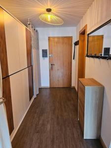 a hallway with a door and a room with wood floors at Amazing studio in Haute-Nendaz in Nendaz