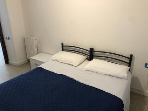 a bed with two pillows on it in a room at Casa vacanze Riomaggiore in Riomaggiore