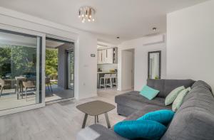 a living room with a couch and a table at Apartment Manuela in Njivice +20 photos