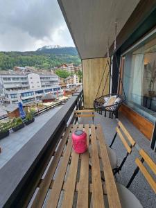 a balcony with a wooden bench on a building at Amazing studio in Haute-Nendaz in Nendaz