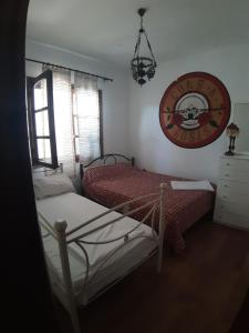 a bedroom with two beds and a sign on the wall at House SOFIA in Stavros