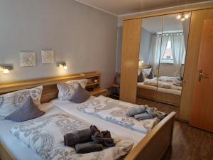 ein Schlafzimmer mit zwei Betten und einem großen Spiegel in der Unterkunft Gästehaus Sophie Randa in Borkum