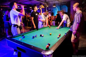 a group of people standing around a pool table at Echo Koh Tao Hostel & Diving in Ko Tao