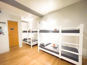 a room with three bunk beds and a hallway at Puerto Princesa Airport Side Hostel in Puerto Princesa City