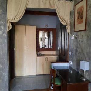 a kitchen with white cabinets and a table at Villa Sagan in Zamárdi