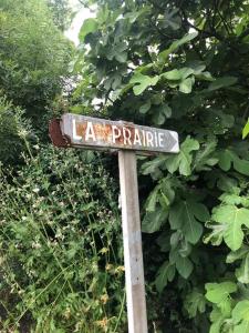 a street sign for la praire in front of a bush at Villa - La Remise in Saint-Michel-en-lʼHerm