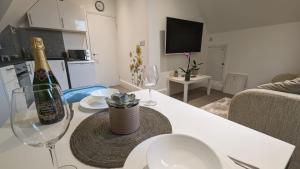 a living room with a bottle of champagne and two wine glasses at Modern spacious apartment in Brighton & Hove