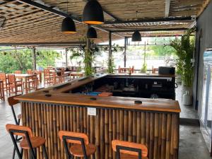 a bar in a restaurant with chairs and tables at Echo Koh Tao Hostel & Diving in Ko Tao