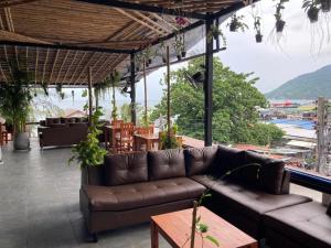 a couch on a patio with a view of the water at Echo Hostel Koh Tao in Ko Tao