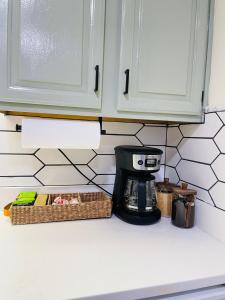 a kitchen counter with a coffee maker and a basket at Newly renovated charming home with parking in Fort Washington