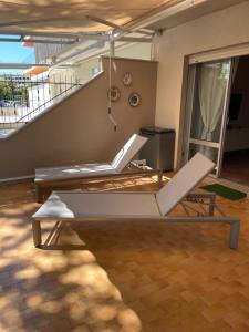 a living room with two chairs and a staircase at Casa Roberta con favolosa terrazza privata in Caorle