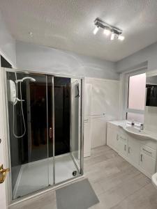 a bathroom with a shower and a sink at Anchorage, a lovely 2nd floor one bedroom apartment with fabulous seaviews in Largs