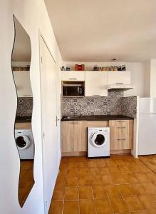 een keuken met 2 wasmachines en een wasmachine en droger bij Studio avec vue sur la Major in Marseille