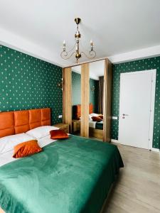 a bedroom with a large bed with an orange headboard at AURA in Kutaisi