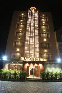 a hotel is lit up at night at HOTEL HOLISTON in Dwarka