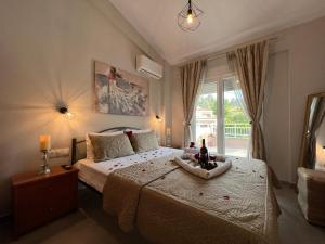 a bedroom with a large bed and a window at Marialena's House in Limenas