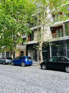 three cars parked in front of a building at AURA in Kutaisi