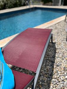 a swimming pool with a red mat next to it at Lou Maset in Saint-Paul-Trois-Châteaux