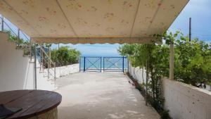 a walkway with a view of the ocean from a building at Joana‘s Rooms in Himare