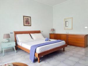 a bedroom with a bed and a dresser and a mirror at Villa Ida in Capo Rizzuto
