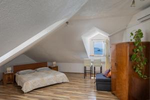 a bedroom with a bed and a table and chairs at Dubrovnik Sunset Apartments in Dubrovnik