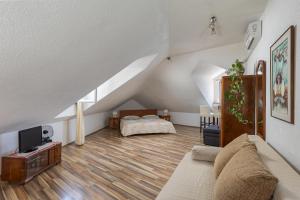 a living room with a couch and a bed at Dubrovnik Sunset Apartments in Dubrovnik