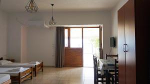a room with two beds and a sliding glass door at Joana‘s Rooms in Himare