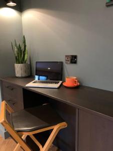 a desk with a laptop computer on top of it at Country Apartment in Hurstpierpoint